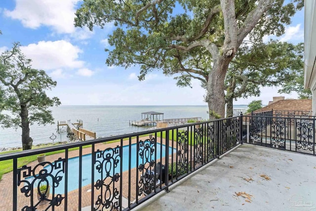 balcony with a boat dock and a water view