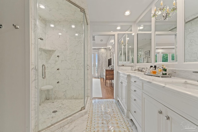 bathroom with double sink vanity, tile patterned flooring, and an enclosed shower