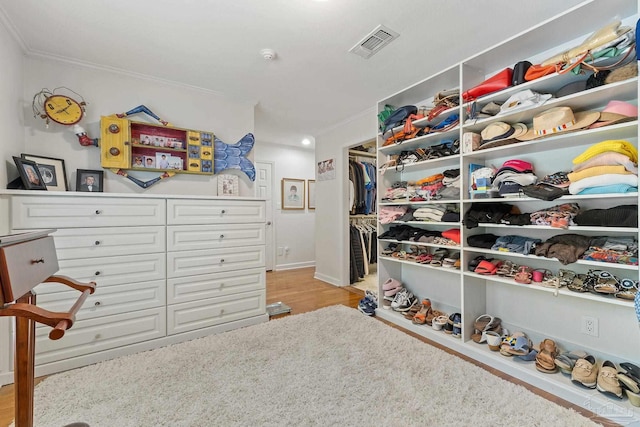 spacious closet featuring light wood-type flooring and visible vents