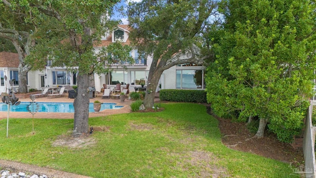 exterior space with a patio and a lawn