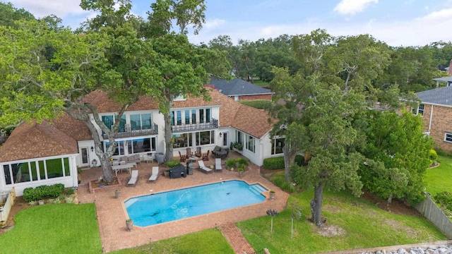 view of swimming pool with a yard and a patio area