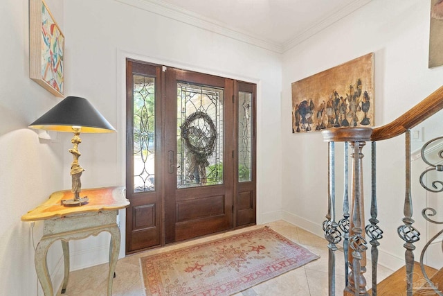 tiled entrance foyer featuring ornamental molding