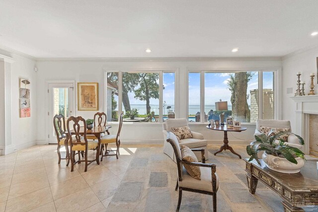 interior space featuring crown molding, light tile patterned floors, recessed lighting, a water view, and baseboards