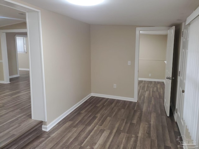 unfurnished bedroom featuring dark wood-style floors and baseboards