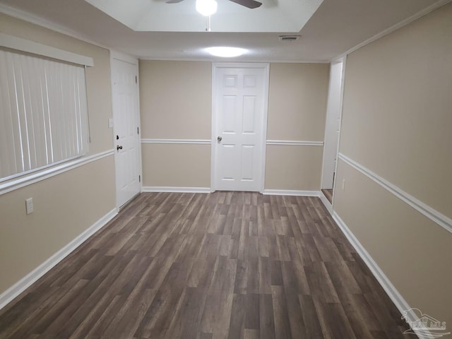 empty room featuring visible vents, baseboards, wood finished floors, and a ceiling fan