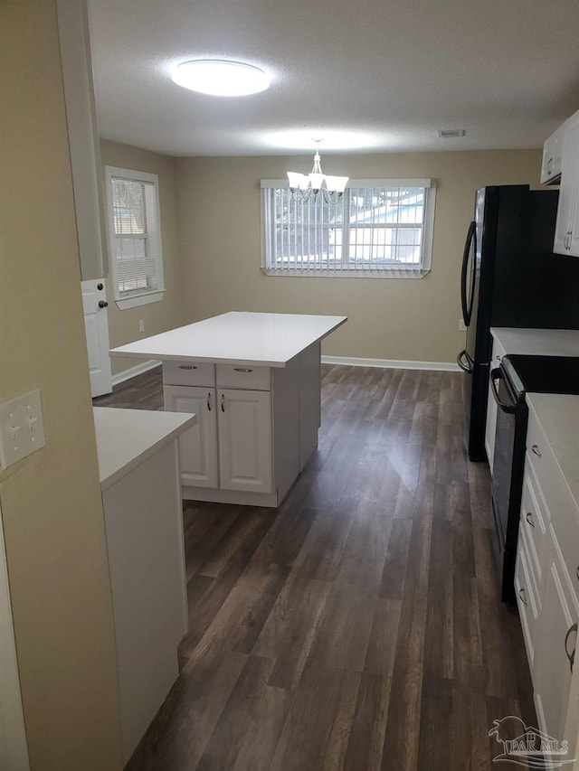 kitchen with black range with electric cooktop, dark wood-style flooring, and white cabinetry