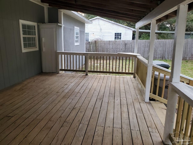 wooden terrace featuring fence