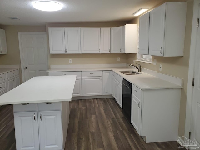 kitchen featuring visible vents, a sink, black dishwasher, dark wood finished floors, and white cabinetry