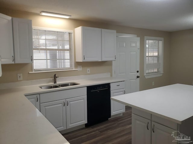 kitchen featuring dark wood finished floors, dishwasher, light countertops, white cabinetry, and a sink