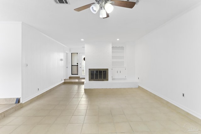 unfurnished living room with built in shelves, crown molding, light tile patterned floors, ceiling fan, and a fireplace