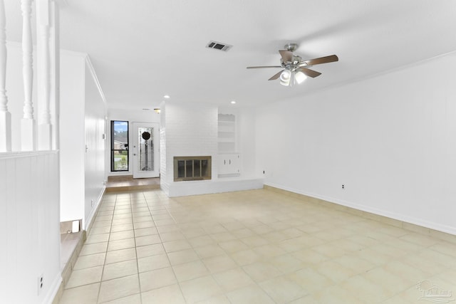 unfurnished living room featuring light tile patterned floors, crown molding, a fireplace, and ceiling fan