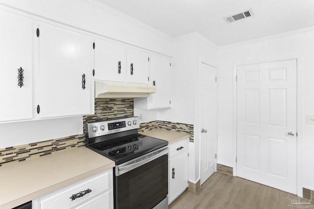 kitchen featuring tasteful backsplash, white cabinets, stainless steel range with electric stovetop, ornamental molding, and light hardwood / wood-style floors