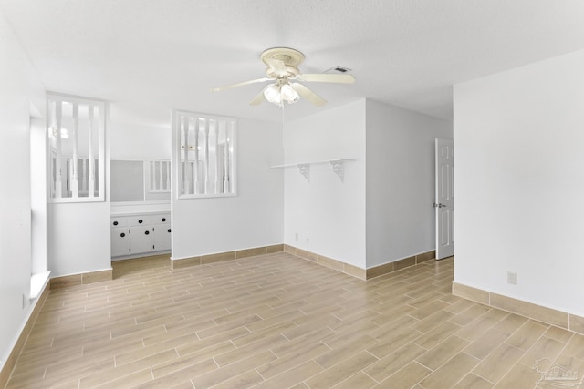 unfurnished room with ceiling fan