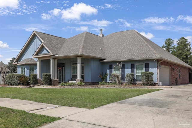 view of front of property with a front lawn, an outbuilding, and a garage