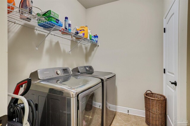 laundry room with separate washer and dryer and light tile patterned floors