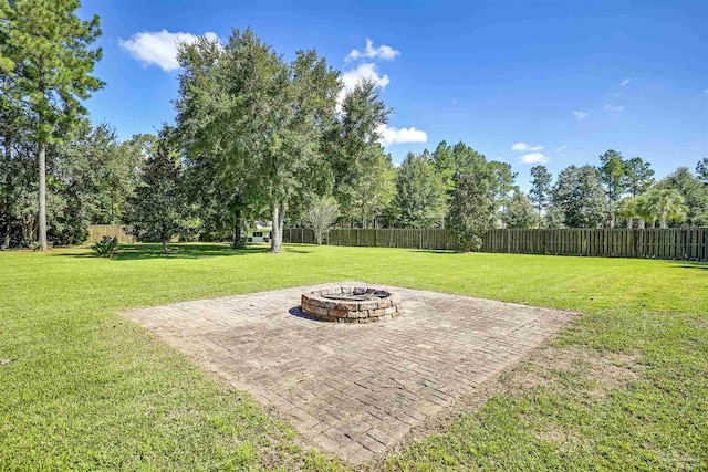 view of yard featuring a fire pit and a patio