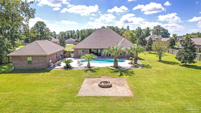 exterior space featuring a lawn, a patio, and an outdoor fire pit