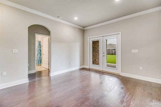 spare room with crown molding, french doors, and hardwood / wood-style flooring