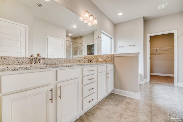 bathroom featuring vanity and a shower with shower door