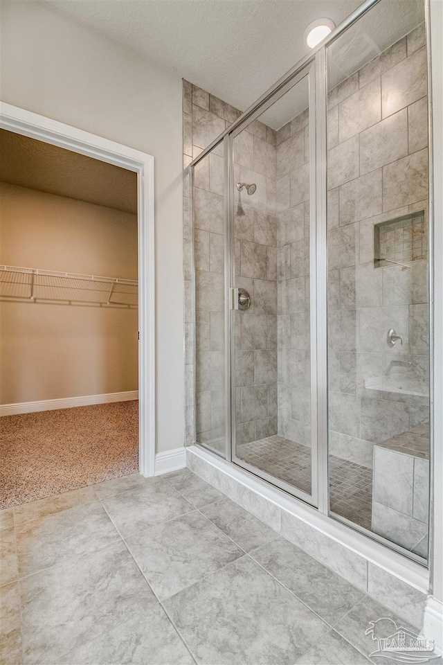 bathroom with a shower with shower door