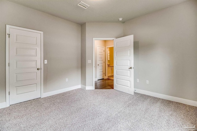 unfurnished bedroom featuring dark carpet