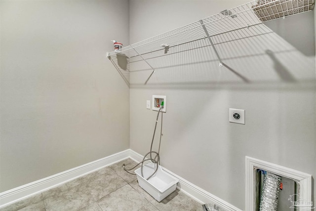 laundry area with tile patterned flooring, hookup for a washing machine, and electric dryer hookup