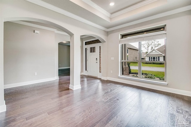 entrance foyer with hardwood / wood-style flooring, crown molding, and a raised ceiling