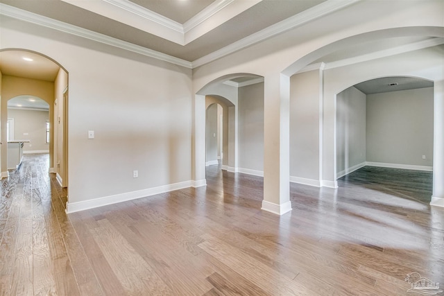 unfurnished room featuring ornamental molding and light hardwood / wood-style floors