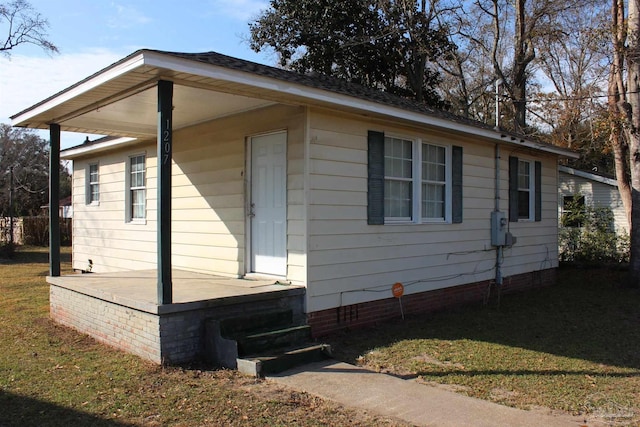 view of side of home with a lawn