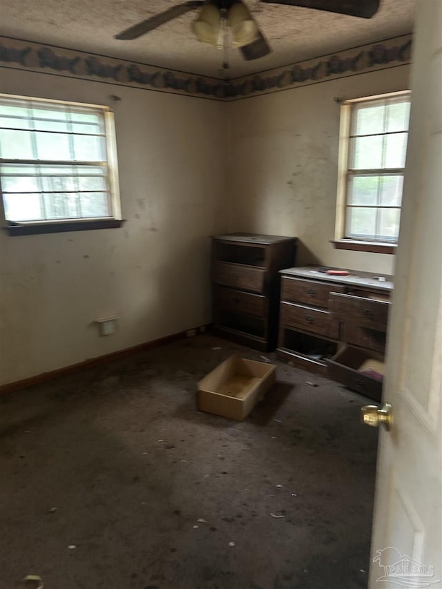 empty room featuring ceiling fan and a textured ceiling