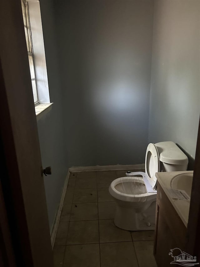 bathroom featuring tile patterned floors, vanity, and toilet