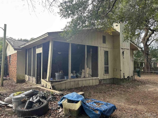 view of side of home featuring a sunroom