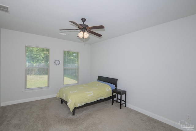 bedroom with ceiling fan and light colored carpet