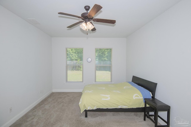 bedroom featuring light carpet and ceiling fan