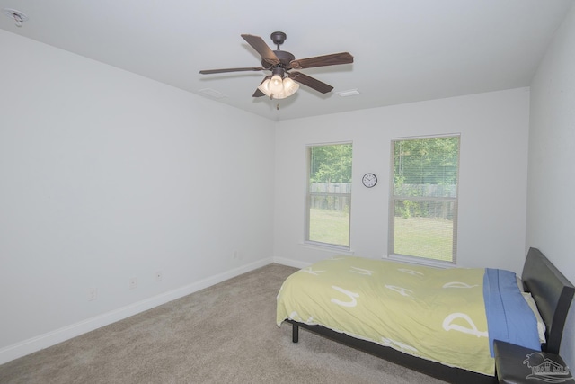 bedroom with ceiling fan and light colored carpet