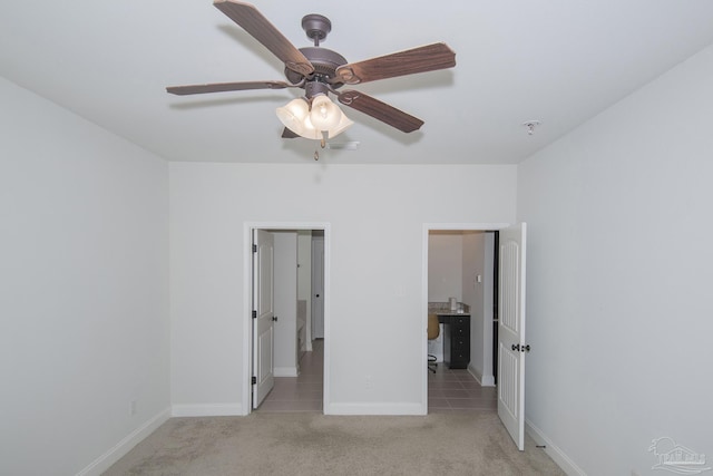 unfurnished bedroom featuring light carpet and ceiling fan