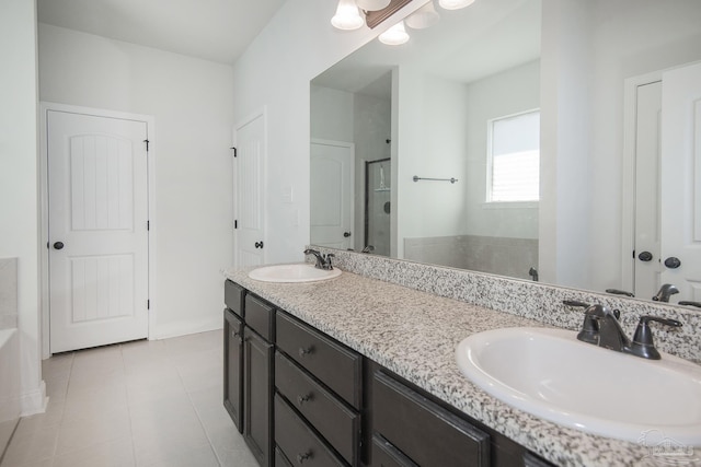 bathroom with tile patterned flooring, vanity, and separate shower and tub