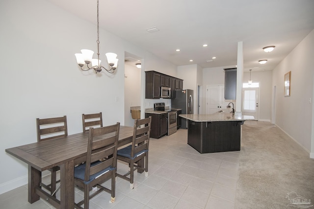 dining room featuring light carpet, a notable chandelier, and sink