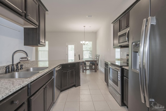 kitchen featuring an inviting chandelier, hanging light fixtures, sink, appliances with stainless steel finishes, and dark brown cabinetry