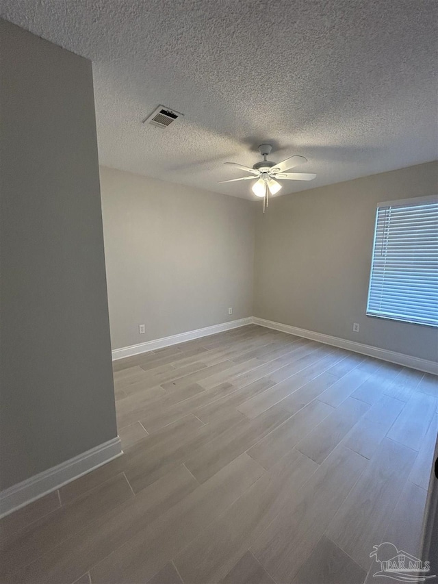 4817 Makenna Cir, Pace, FL 32571 - unfurnished room featuring wood finished floors, visible vents, a ceiling fan, and baseboards