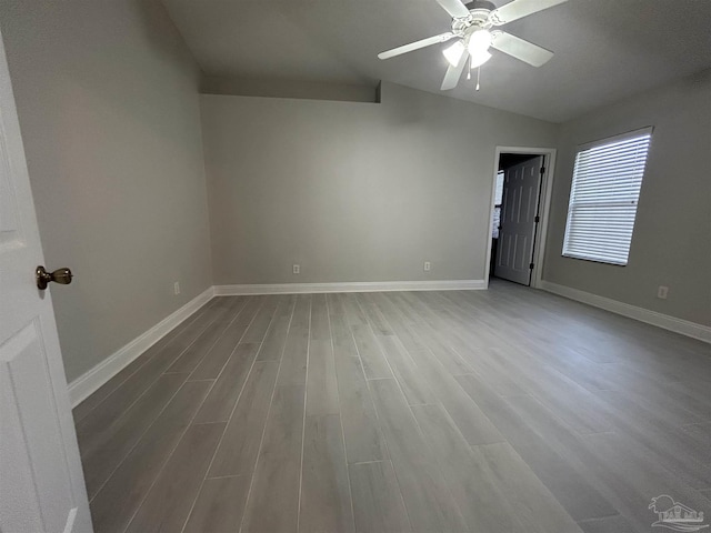 4817 Makenna Cir, Pace, FL 32571 - unfurnished room featuring baseboards, wood finished floors, ceiling fan, and vaulted ceiling