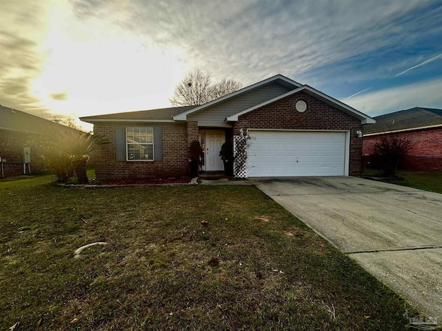 ranch-style house with a garage and a yard