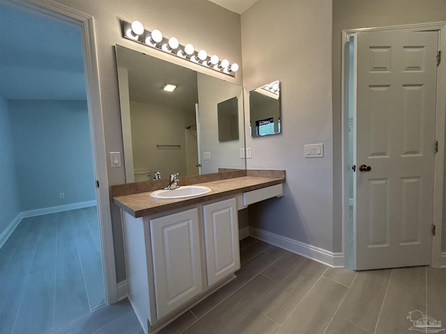 4817 Makenna Cir, Pace, FL 32571 - bathroom featuring baseboards, wood finish floors, and vanity
