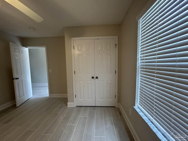 4817 Makenna Cir, Pace, FL 32571 - unfurnished bedroom featuring wood finished floors, a closet, and baseboards