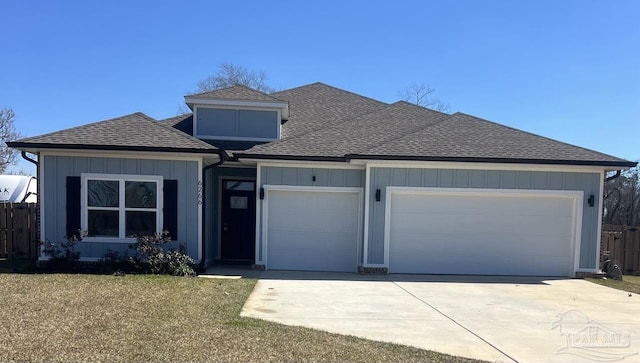 view of front of home featuring an attached garage, fence, driveway, roof with shingles, and board and batten siding