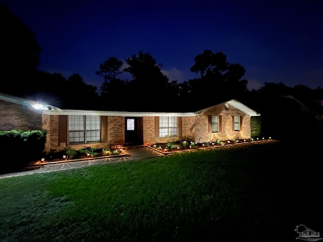 ranch-style house with a yard