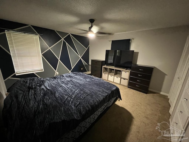 carpeted bedroom featuring a closet, ceiling fan, and a textured ceiling