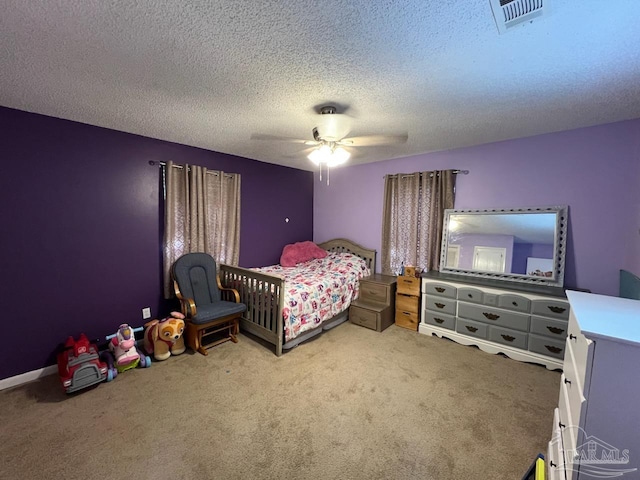 bedroom with ceiling fan, a textured ceiling, and carpet floors