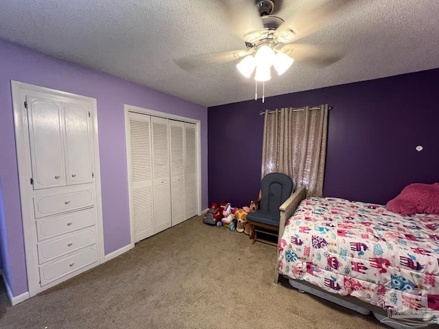 carpeted bedroom featuring ceiling fan and a textured ceiling