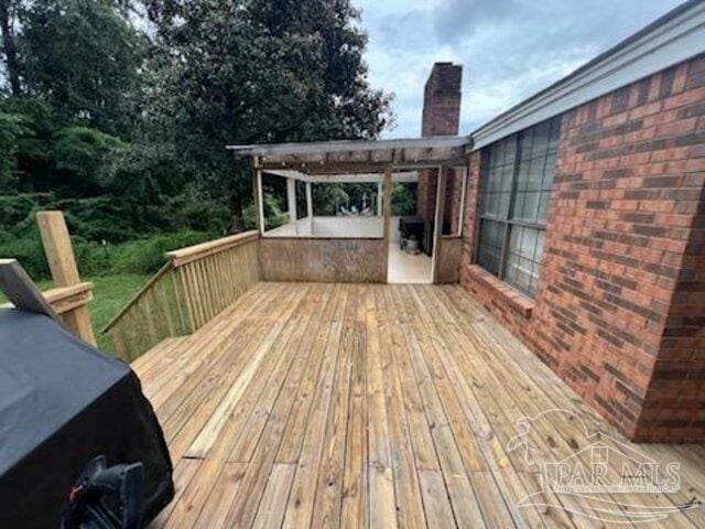 wooden deck featuring a pergola